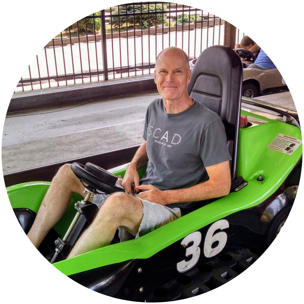 Photograph of Mark Moffett operating a go-kart.