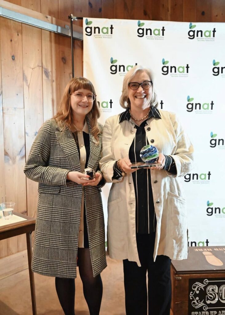 Caren McVicker (right) standing next to Jess Hunsicker (left), holding their GNATTY awards.